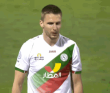 a soccer player wears a jersey that says jako on the front