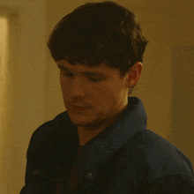 a man in a blue jacket with the words definitely not below him