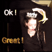 a girl with a crown on her head holds a banana in front of a sign that says ok great