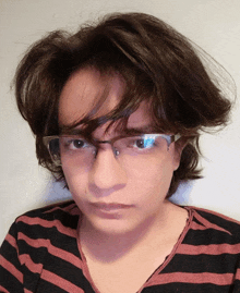 a woman wearing glasses and a striped shirt
