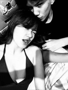 a black and white photo of a man and a woman with a sticker on the wall that says i love
