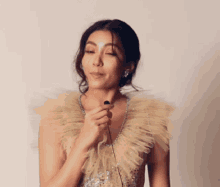 a woman in a dress is holding a microphone in her hand .