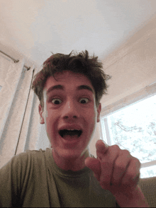 a young man with a bandage on his face making a funny face