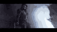 a silhouette of a person with a mask on standing in the dark