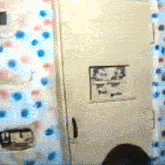 a bathroom with a toilet , shower curtain , and door .