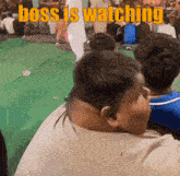 a group of people are sitting in a room with the words boss is watching