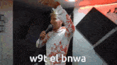 a man singing into a microphone with the words w9t el bnwa written on the bottom