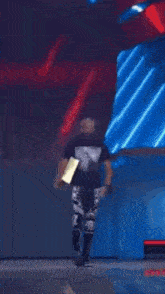 a man holding a trophy in front of a sign that says r