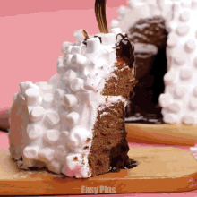 a piece of cake on a cutting board that says easy plus on the bottom