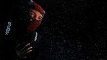 a person is flying through the air in a dark room with a light shining on them .