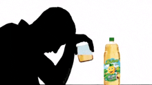 a silhouette of a man holding a glass of beer next to a bottle of juice .