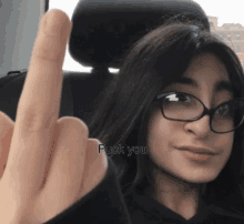 a woman wearing glasses giving the middle finger with the words fuck you below her