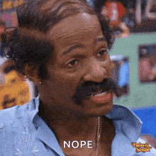 a man with a mustache is making a funny face and saying nope