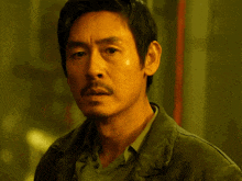 a close up of a man 's face with a serious look on his face