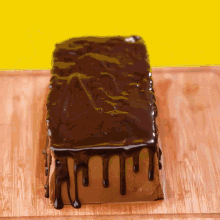 a loaf of chocolate cake is sitting on a cutting board