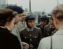 a group of soldiers are talking to a woman