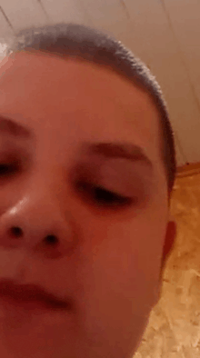 a close up of a man 's face with his eyes closed .