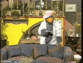 a man in a duck costume is standing next to a couch in a living room ..