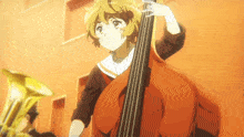 a girl playing a double bass in front of a trumpet