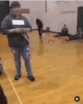 a group of people are dancing in a gym .
