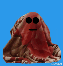 a red blanket with a smiling face and the word yes on it