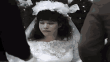 a woman in a wedding dress is standing next to a man