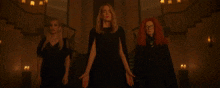 a group of people are standing in a dark room with a sign that says ' i 'm a girl '