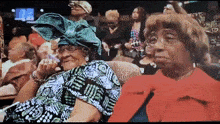 a woman in a green turban sits next to another woman