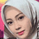 a close up of a woman wearing a white scarf around her head