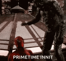 a man in a spiderman costume is standing next to another man in a spiderman costume .