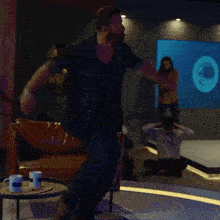 a man with a beard is dancing on a stage with his arms outstretched