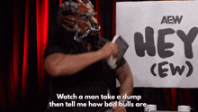a man in a demon mask stands in front of a sign that says hey