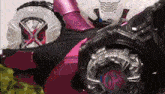 a close up of a pink and black toy car with a clock on it