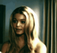 a close up of a woman 's face with blonde hair