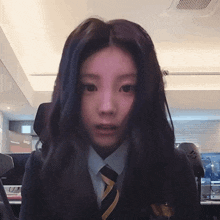 a girl in a suit and tie with a purple hair color