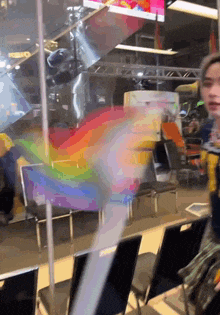 a rainbow is painted on a glass wall in an airport waiting area