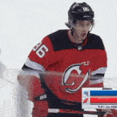 a hockey player wearing a red and black jersey with the number 36 on it