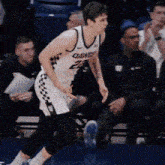 a basketball player with the number 23 on his jersey is running on the court