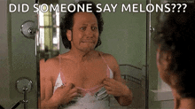 a man in a pink bra is looking at himself in the mirror and asking if someone said melons .