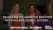a woman is reuniting her adopted brother with his biological sisters while holding a clipboard .