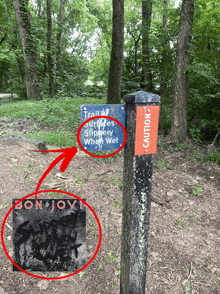 a sign that says trail surfaces slippery when wet is next to a sign that says caution