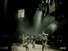 a group of people dancing on a stage with a rbd.gif watermark
