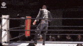 a man in a wrestling ring with a sign that says ' i didpro ' on it .