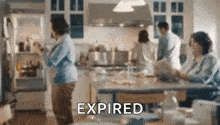 a group of people are standing in a kitchen with a refrigerator open and the word expired written on the bottom .