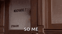 a man is peeking out of a window and saying `` some me '' .