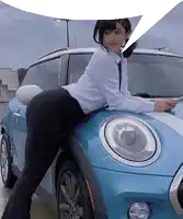 a woman leaning on a blue mini cooper with a speech bubble above her head