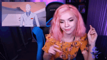 a woman with pink hair is sitting in front of a chair that says dxr on it