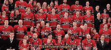 a group of hockey players are posing for a photo and the caption says everyone laughs