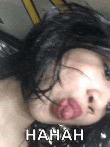 a woman with a pink balloon in her mouth has the word hahah written on her face