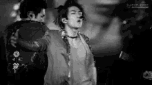 a black and white photo of a man dancing with another man .